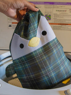 Scotch the penguin washbag going into the washing machine